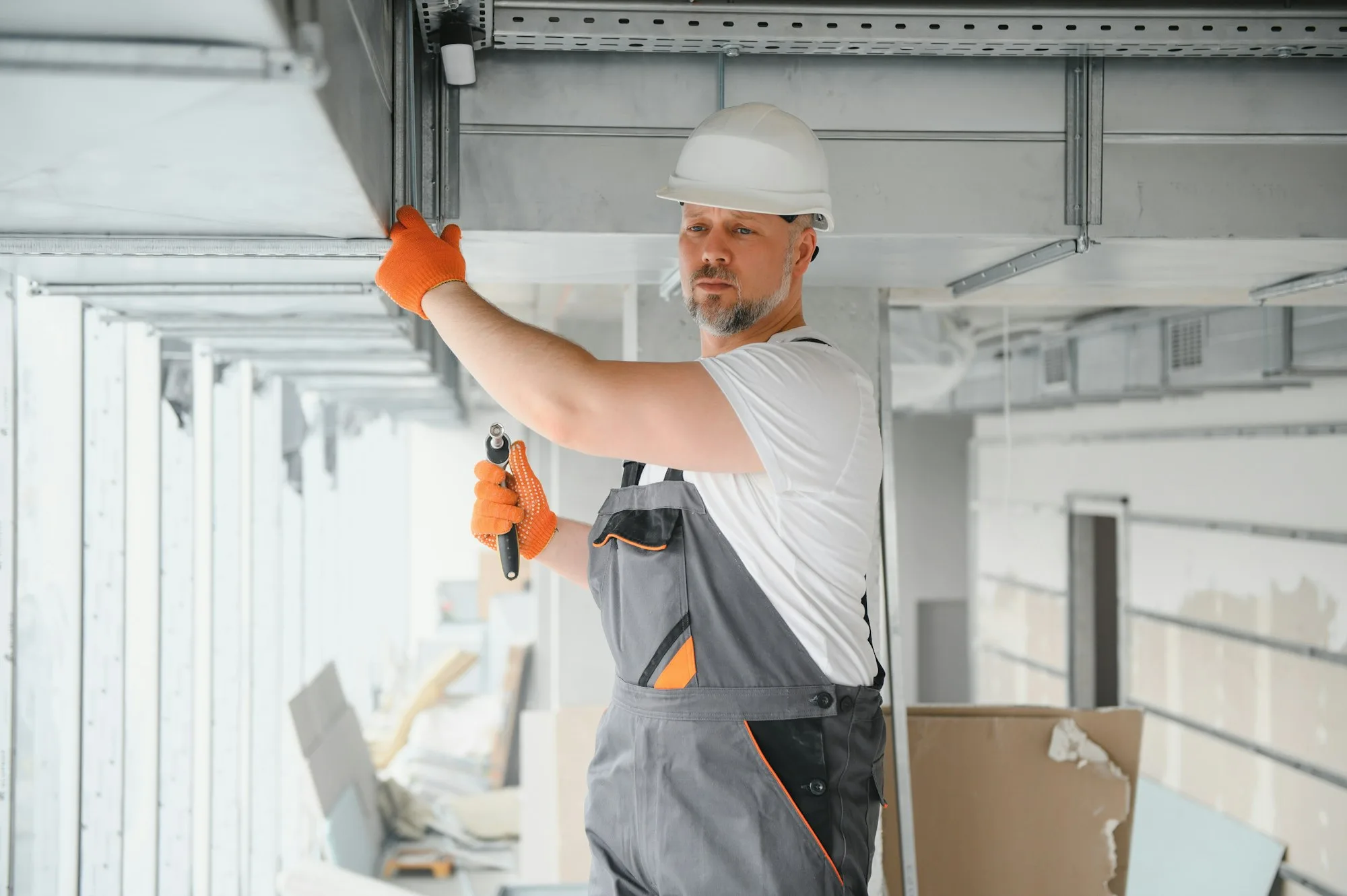 101 Prime technician installing a ducted ventilation and air conditioning system